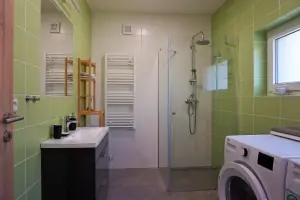 koupelna se sprchovým koutem, umyvadlem, pračkou a sušičkou